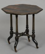 A Victorian coromandel side table
The line inlaid octagonal top supported on gilt and ebonised