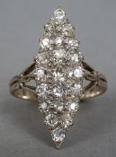 An 18 ct gold diamond cluster ring
Of lozenge form, with pierced shoulders.