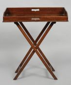 A 19th century mahogany butlers tray on stand
With three quarter raised gallery and twin carrying