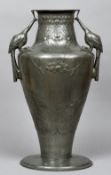 An Art Nouveau pewter vase
With twin peacock form handles,