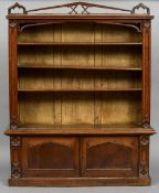 A Victorian oak Gothic Revival standing bookcase
The rectangular top with a pierced back rail