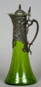 An Art Nouveau green glass claret jug
With floral pewter mounts.  33 cm high.