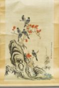 A Chinese painted scroll
Worked with birds perched on flowering boughs issuing from a pierced rock,