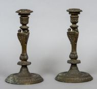 A pair of 19th century bronze candlesticks
The hexagonal tops above the mask headed column,