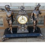 A bronzed mantel clock
Surmounted with cavaliers.  52 cm high.