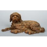 A late 19th century Black Forest carved double inkwell
Modelled as a recumbent shaggy dog.  28.