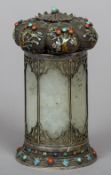 An unmarked Chinese silver, enamel and cabochon stone mounted jade pot
Of cylindrical form,