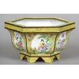 A Chinese Canton enamelled jardiniere
Of hexagonal form, decorated with figural and bird vignettes,
