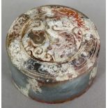 A Chinese carved hardstone seal
Of circular section, carved with a dragon,