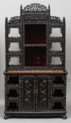 A 19th century Chinese carved hardwood side cabinet
The pierced shelved top section with a central
