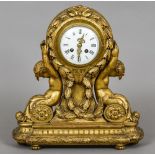 A late 19th/early 20th century carved giltwood mantel clock
The white enamelled dial with Roman