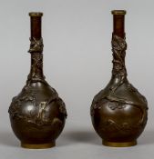 A pair of Japanese bronze vases
Each decorated with birds amongst flowering blossom.  24 cm high.