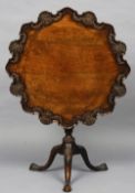 A 19th century mahogany tilt-top wine table
The shaped top with shell and acanthus carving,