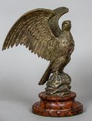 A silvered bronze  model of an eagle
Naturalistically modelled on a rock y outcrop,