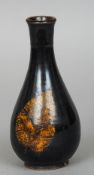 A Chinese porcelain bottle vase 
With leaf decoration.  19.5 cm high.