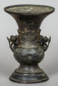 A Chinese bronze archaistic style vase
The flared rim above the twin pierced floral handles,