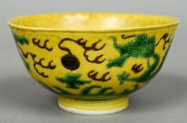 A Chinese porcelain bowl
Decorated with dragons on a yellow ground,