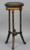 A 19th century ebonised and amboyna jardiniere stand
The circular top with gilt brass beading above