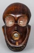 An African carved wooden skull mask
With cowrie shell inset eyes.  18 cm long.