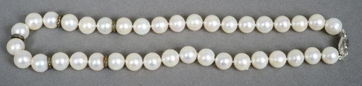 A pearl necklace
Set with an 18 ct white gold clasp and diamond chip set dividers.  43 cm long.