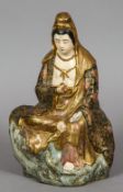 A Japanese porcelain figure of Guanyin
Worked seated on a rocky outcrop.  29.5 cm high.