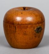 A 19th century fruitwood apple form tea caddy
Of typical form, with a brass escutcheon.  10 cm high.