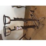 A pair of antique iron firedogs
Each with a pair of ratcheted supports.  81 cm high.