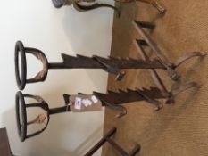 A pair of antique iron firedogs
Each with a pair of ratcheted supports.  81 cm high.