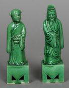 A pair of Chinese porcelain figures of a sage and his companion Both with allover green glaze. 15.