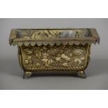 A 19th century Japanese repousse decorated planter The lappet set border above panels decorated