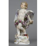 A 19th century Meissen figure of cupid Modelled bound in roses, a quiver by his feet. 18.5 cm high.