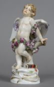 A 19th century Meissen figure of cupid Modelled bound in roses, a quiver by his feet. 18.5 cm high.