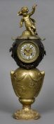 A putto mounted ball clock With white and black enamelled Roman numerals. 63 cm high.