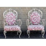 A pair of upholstered white painted wrought iron conservatory chair Each with scrolling organic