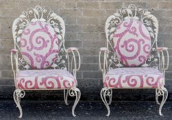 A pair of upholstered white painted wrought iron conservatory chair Each with scrolling organic