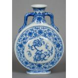 A Chinese blue and white porcelain twin handled moon flask Decorated with peach vignettes within a