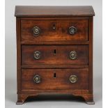 A 19th century mahogany miniature chest of drawers The moulded rectangular top above three drawers