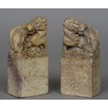 A pair of Chinese carved stone models of dragons Each standing on an ornately florally carved