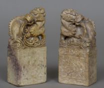 A pair of Chinese carved stone models of dragons Each standing on an ornately florally carved