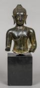 An antique patinated bronze model of Buddha Typically modelled formed as head and torso,