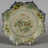 A plique-a-jour plate Of lobed form, decorated with flowers. 23 cm diameter.