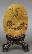 A Chinese carved hardstone plaque, possibly butterscotch jade Of oval form,