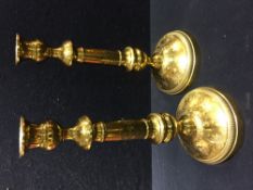 A pair of Victorian brass candlesticks Each engraved with foliate sprays and scrollwork. 29.