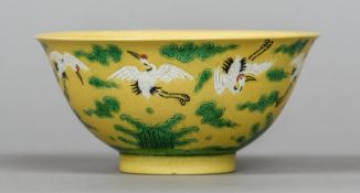 A Chinese porcelain bowl Decorated with cranes in flight amongst stylised clouds and above stylised