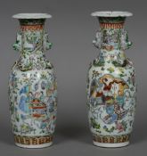 A pair of 19th century Cantonese porcelain vases Each decorated with various figures in interiors