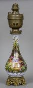 A 19th century gilt bronze and brass mounted porcelain oil lamp The main body painted with a