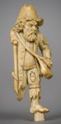 A 19th century Dieppe carved ivory figure of a beggar Modelled in tatty torn clothing and wearing a