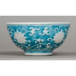 A Chinese porcelain bowl Relief moulded with lotus strapwork on a turquoise ground,