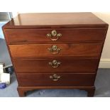 A George III mahogany chest of drawers The caddy top above four long graduated drawers standing on