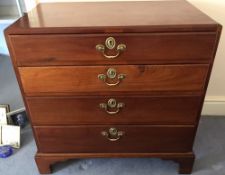 A George III mahogany chest of drawers The caddy top above four long graduated drawers standing on